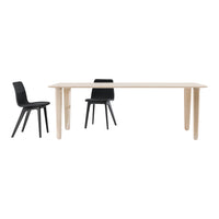 Modern wooden dining table in light natural finish paired with sleek black chairs for a stylish contrast.