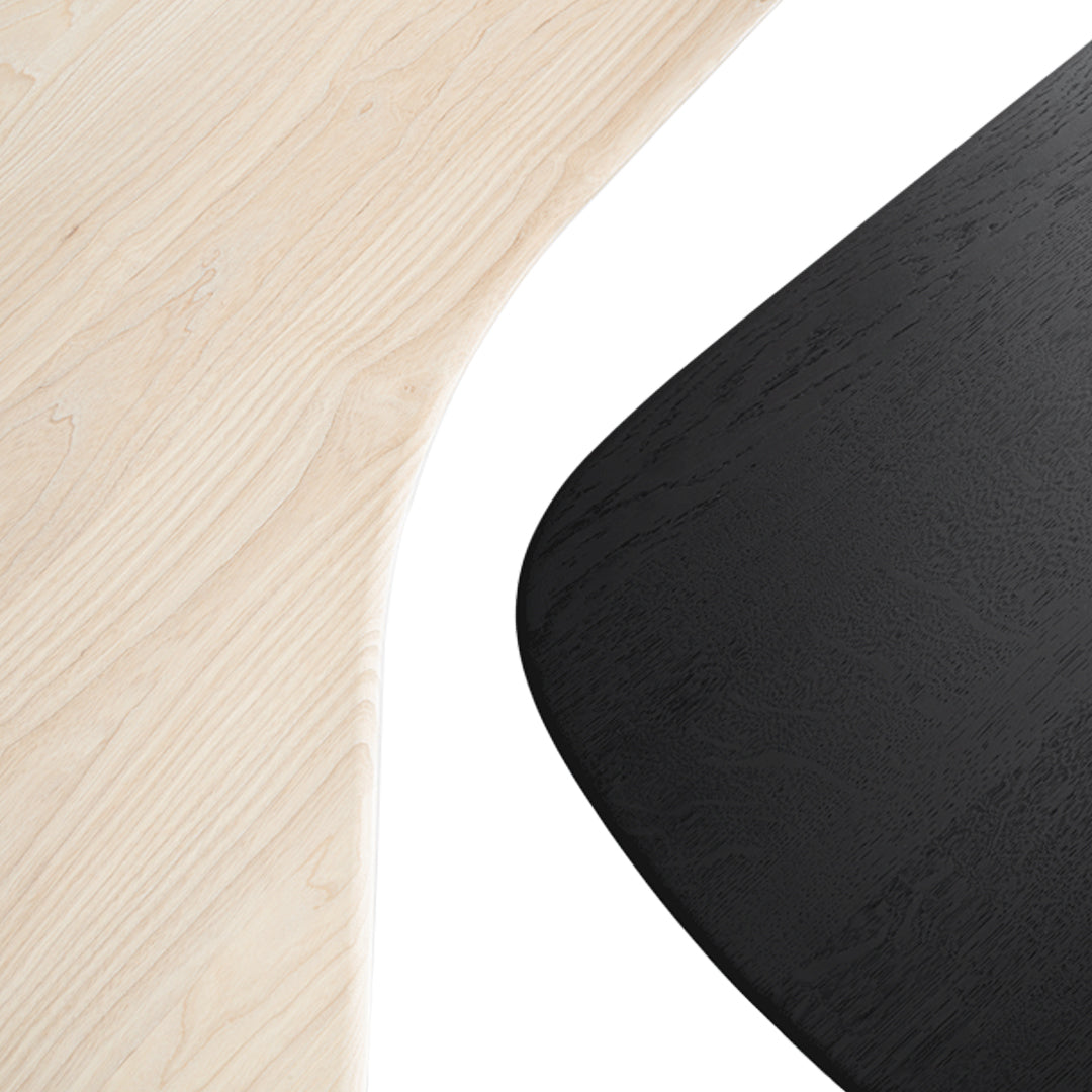 Modern wood table with light natural grain and sleek black matte finish, showcasing a trendy dual-tone design.