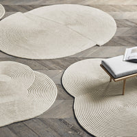 Beige area rugs with concentric circular patterns on a wooden floor. Stylish and modern for any decor.