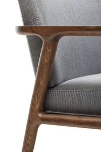 Gray upholstered chair with a wooden frame showcasing a sleek, minimalist design.