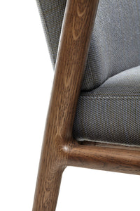 Gray textured fabric upholstery with a warm wood frame, showcasing a modern and stylish design.