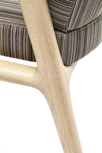 Soft beige wood frame supporting striped gray upholstery, showcasing a modern, textured pattern and neutral earthy tones.