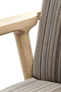 Striped upholstery in earthy tones of brown and beige with light wood accents. Modern design for stylish comfort.