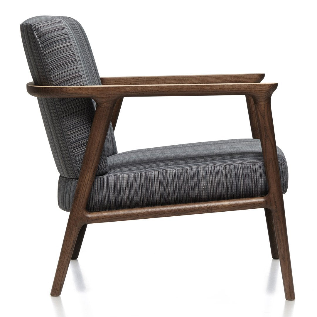 Mid-century modern chair featuring gray striped upholstery and a walnut wood frame. Perfect blend of color and texture.