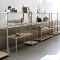 Light wood shelving unit featuring a minimalist design with clean lines, perfect for contemporary decor.